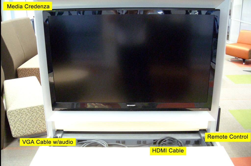 Media credenza, HDMI and VGA cables, and stowed remote control in the media equipment lectern