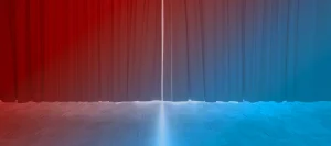 Stage with closed curtains. A bright light emanates from behind.